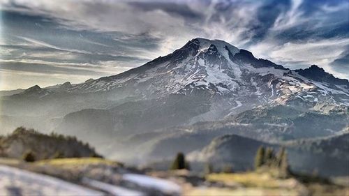 Scenic view of mountains against cloudy sky