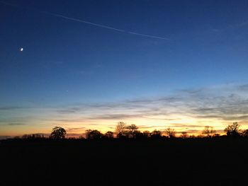 Silhouette trees against sky during sunset