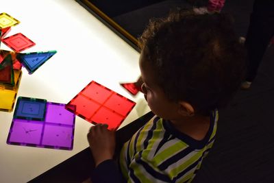 Side view of girl playing with toys on table