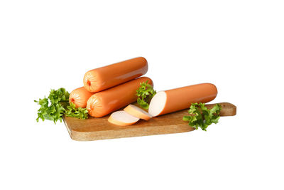 Close-up of vegetables on cutting board against white background