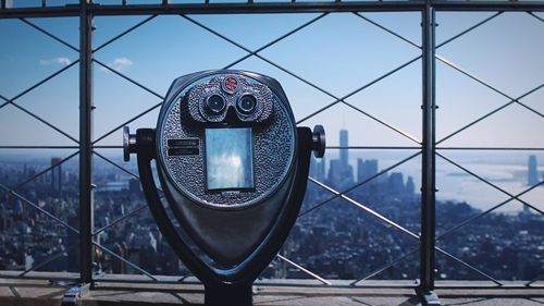 Close-up of coin-operated binoculars at observation point in city