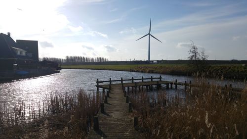 Scenic view of wet farm against sky