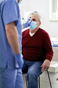 Midsection of man using mobile phone