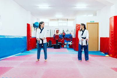 Women practicing martial art in gym