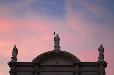 Low angle view of statue against sky during sunset