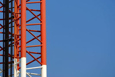 Low angle view of metallic structure against clear blue sky