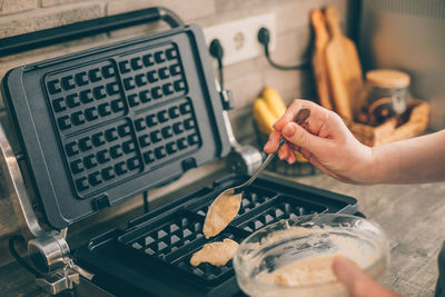 Cropped hand of person preparing food