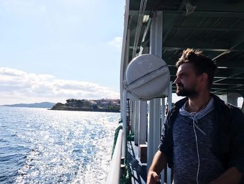 Side view of mid adult man on boat sailing in sea