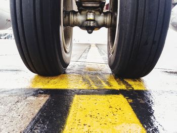 Close-up of yellow tire on road