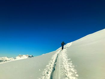 Low angle view of man skiing on snowcapped mountain