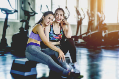 Portrait of a smiling young woman sitting outdoors
