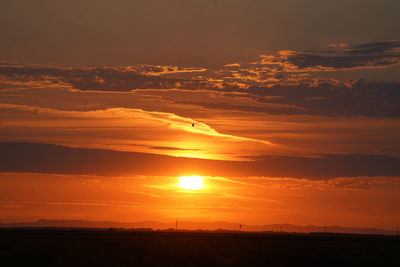 Scenic view of silhouette landscape against romantic sky at sunset