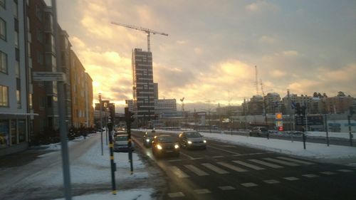 Cars on road at sunset