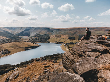 Man looking at view of mountain against sky