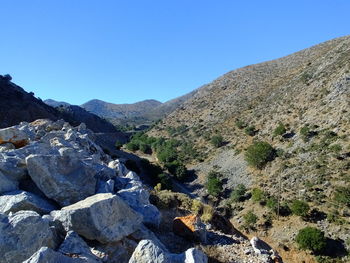 Scenic view of mountains against clear blue sky