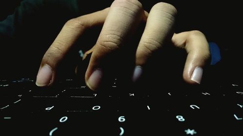 Close-up of human hand on wall