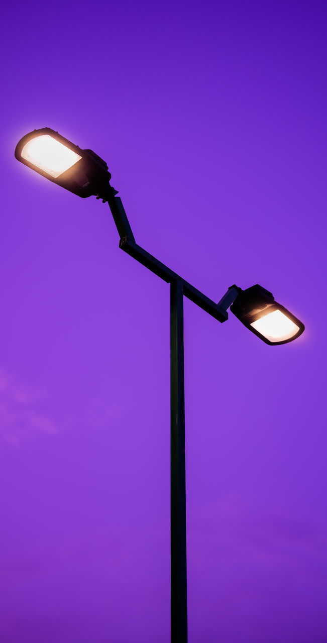 street light, lighting equipment, light fixture, illuminated, lamp, lighting, light, electricity, electric lamp, no people, low angle view, blue, street, purple, sky, electric light, colored background, technology, copy space, light - natural phenomenon
