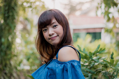 Portrait of young woman standing outdoors