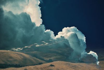 Scenic and surreal view of clouds over tuscany land