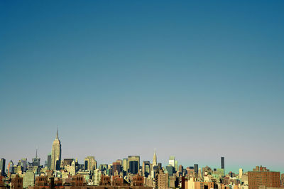 Panoramic view of buildings against blue sky