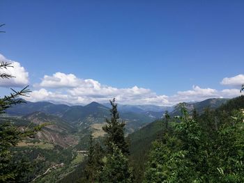 Scenic view of mountains against cloudy sky