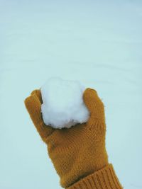 Close-up of hand holding snowball