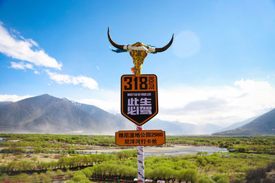 Low angle view of road sign against sky