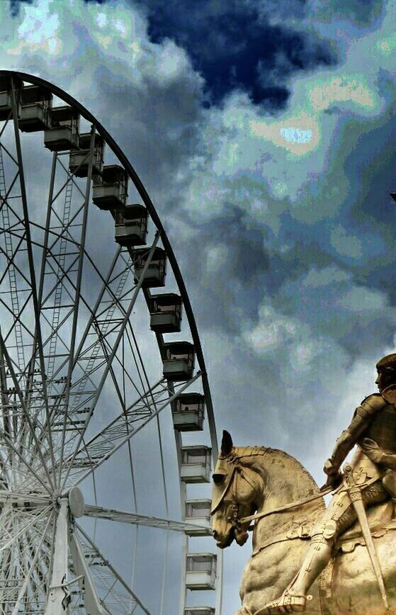 low angle view, sky, cloud - sky, cloudy, built structure, architecture, arts culture and entertainment, cloud, amusement park, amusement park ride, metal, ferris wheel, day, famous place, travel, travel destinations, international landmark, outdoors, tourism, part of