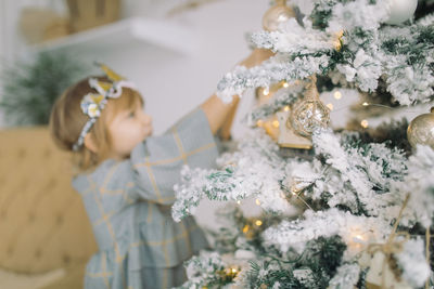 Rear view of woman looking at camera