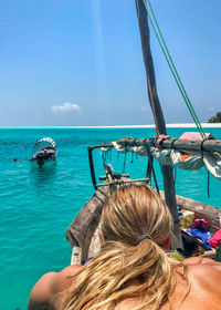 Rear view of woman in boat on sea