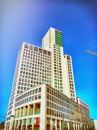 Low angle view of buildings against clear blue sky