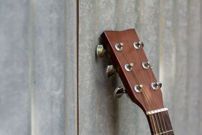 Close-up guitar on corrugated iron