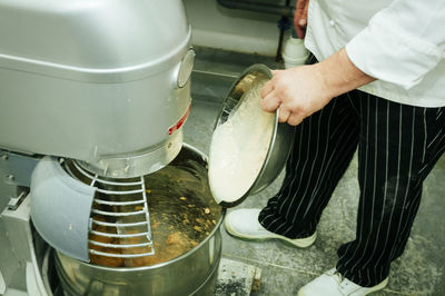 Midsection of man preparing food in kitchen