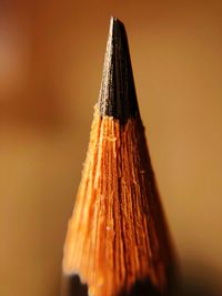 Close-up of colored pencils against orange background