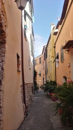 Alley amidst buildings against sky