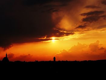 Silhouette of landscape against dramatic sky