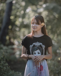 Portrait of smiling girl standing outdoors