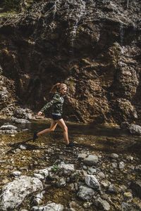 Side view of woman running in lake