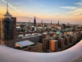 Aerial view of buildings in city during sunset