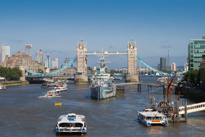 Boats in river with city in background