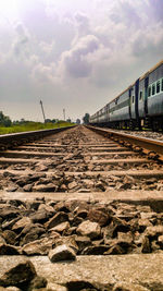 View of railroad tracks against cloudy sky