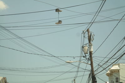 Low angle view of electricity pylon against sky