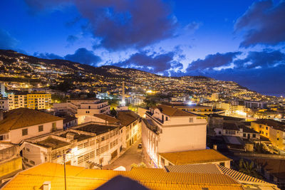 High angle view of illuminated buildings in city at night