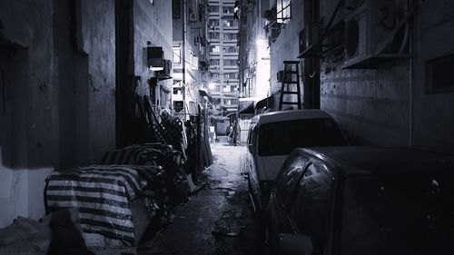 Cars parked amidst buildings at night