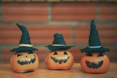 Close-up of pumpkins against orange wall