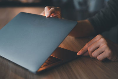 Midsection of woman using laptop