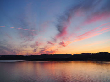 Scenic view of lake against romantic sky at sunset