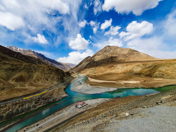 Panoramic view of road by mountains against sky