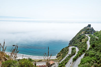 Sant'alessio castle covered by fog. beauty in sicily as a tourist attraction. mediterranean sea