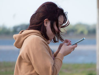 Woman texting with smartphone